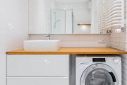 93457844-white-bathroom-with-countertop-basin-big-mirror-and-washer.jpg